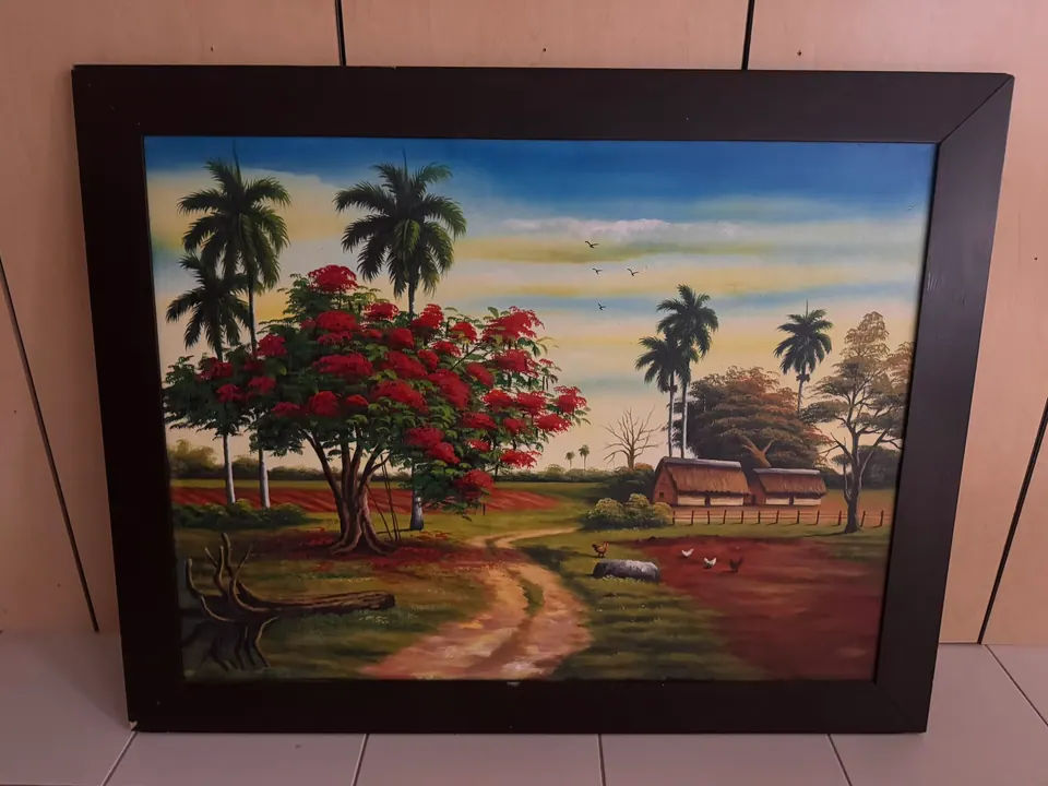 A Cuban country road with royal palms and a red flamboyán tree